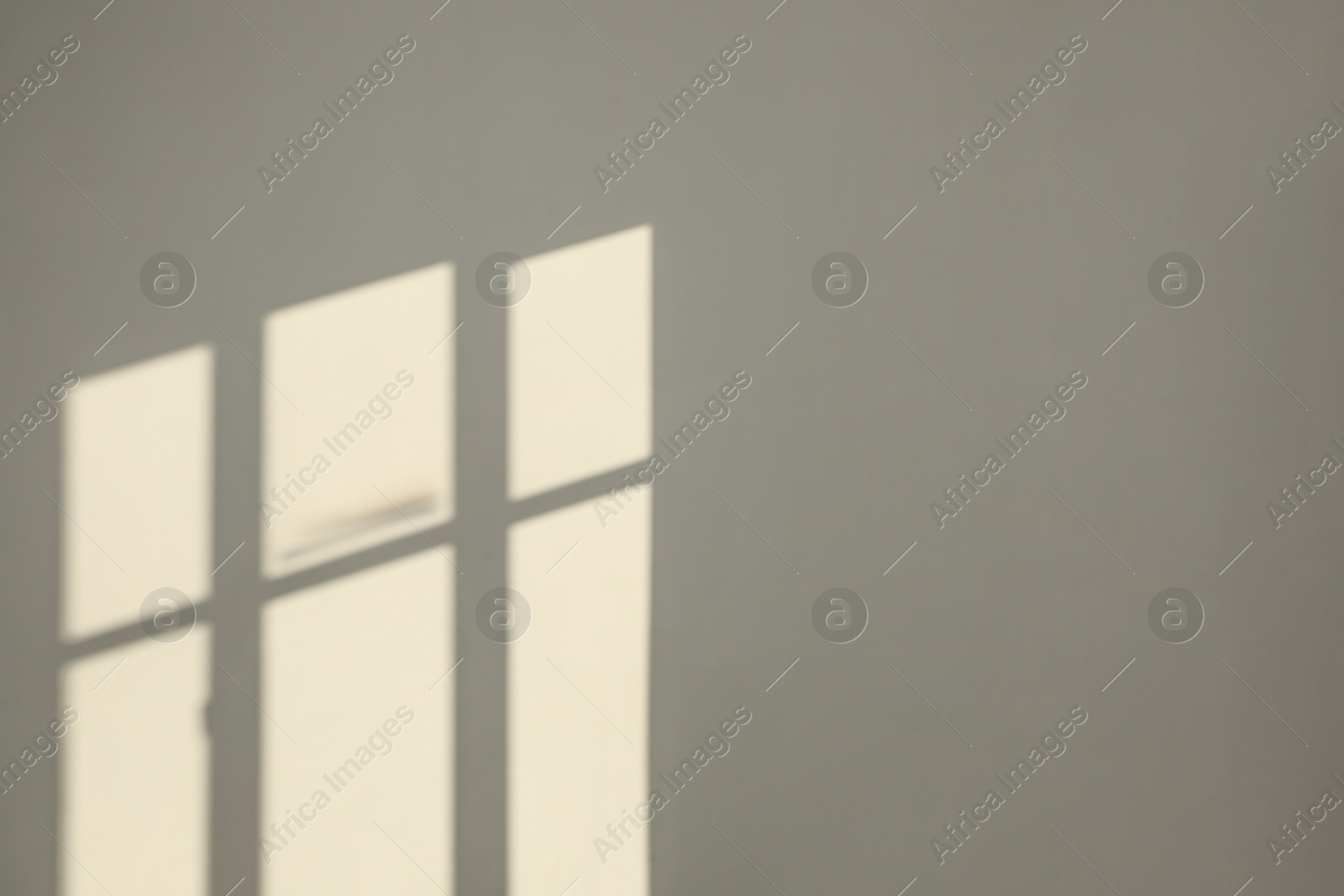 Photo of Light and shadows from window on wall indoors