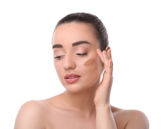 Photo of Woman with swatches of foundation on face against white background