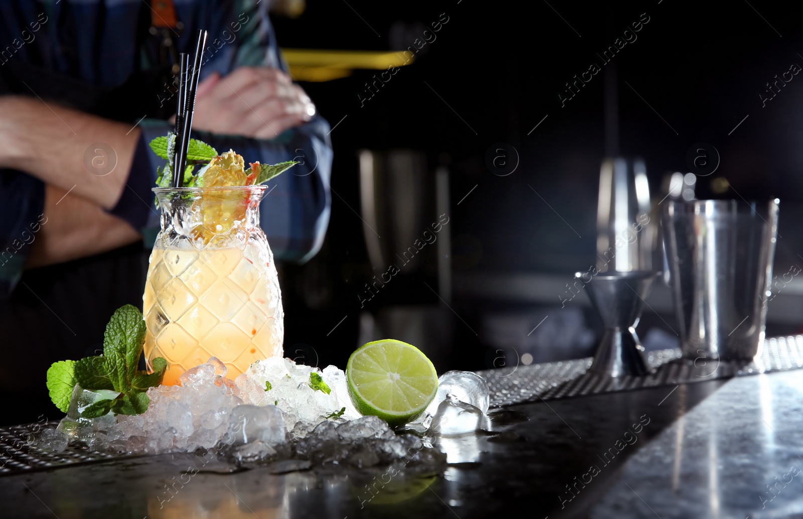 Photo of Fresh alcoholic Malibu and pineapple juice cocktail on bar counter. Space for text