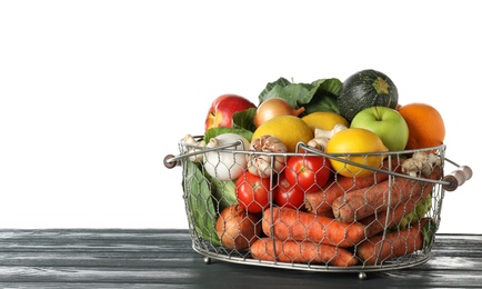 Photo of Variety of fresh delicious vegetables and fruits in basket on table against white background, space for text