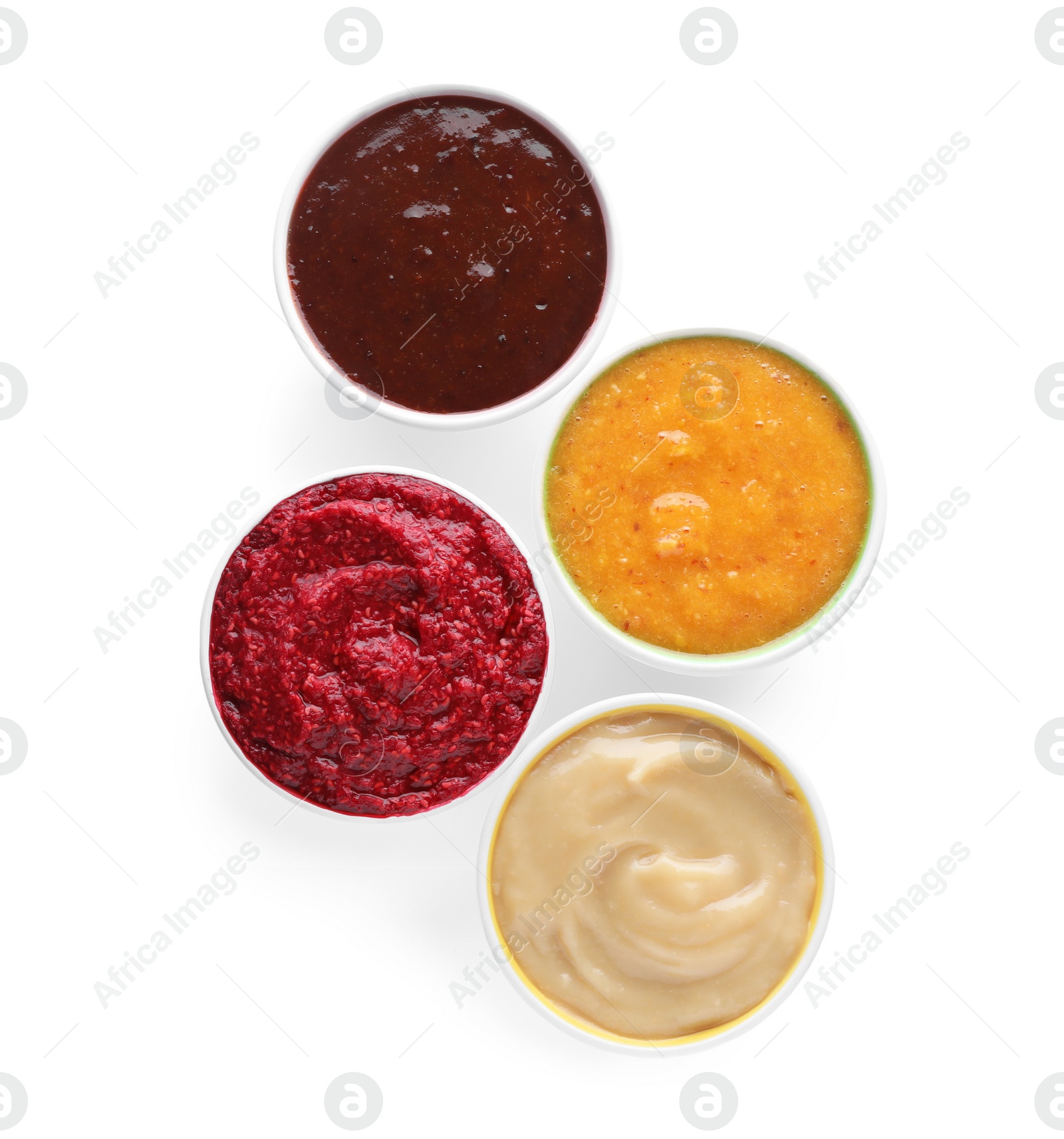Photo of Different fruit and berry puree in bowls on white background, top view