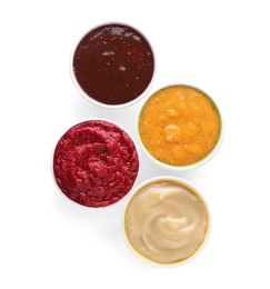 Photo of Different fruit and berry puree in bowls on white background, top view
