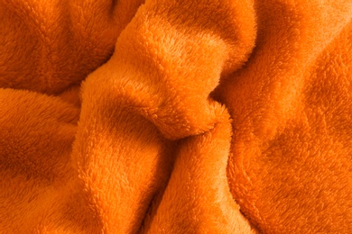 Photo of Fluffy crumpled orange fabric as background, top view