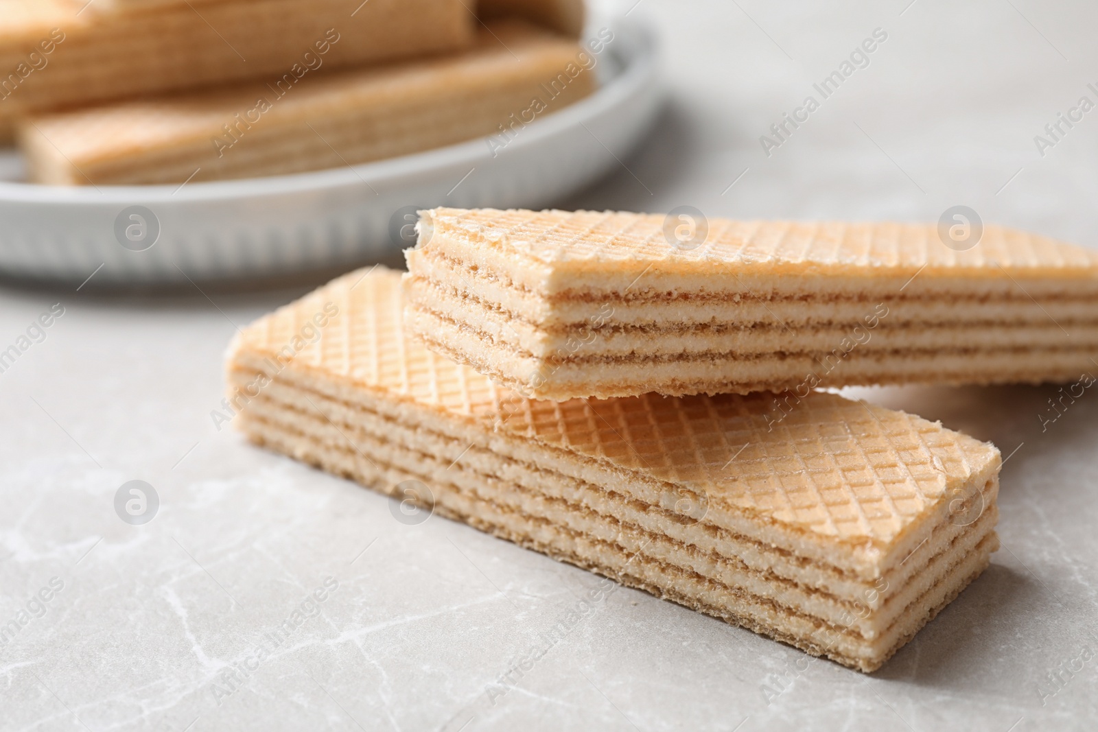 Photo of Delicious cream wafers on light grey marble table, closeup