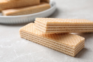 Delicious cream wafers on light grey marble table, closeup