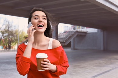 Young woman talking on mobile phone outdoors