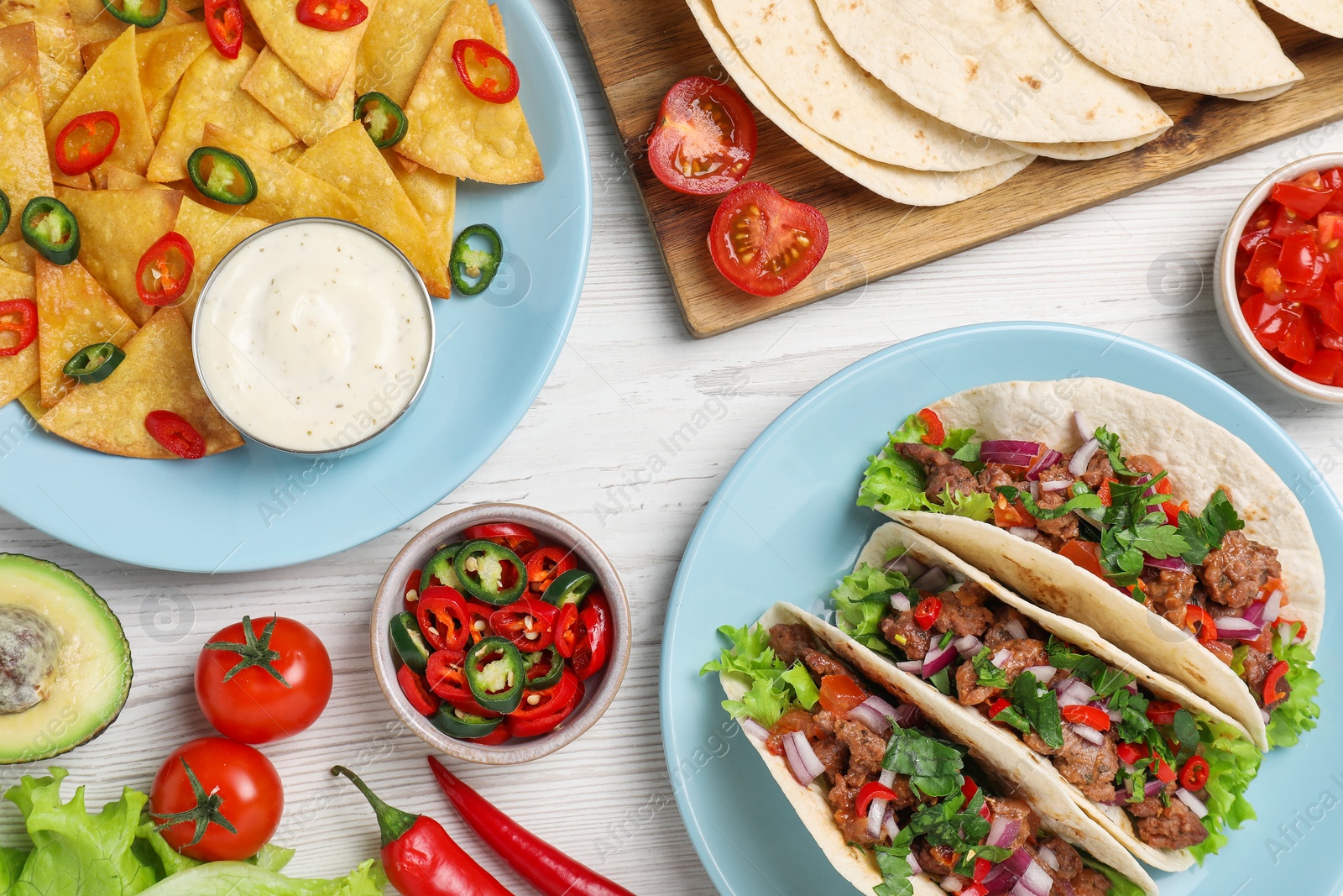 Photo of Flat lay composition with delicious tacos on wooden table