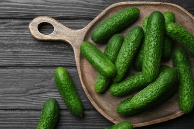 Photo of Fresh ripe cucumbers on dark wooden table, flat lay