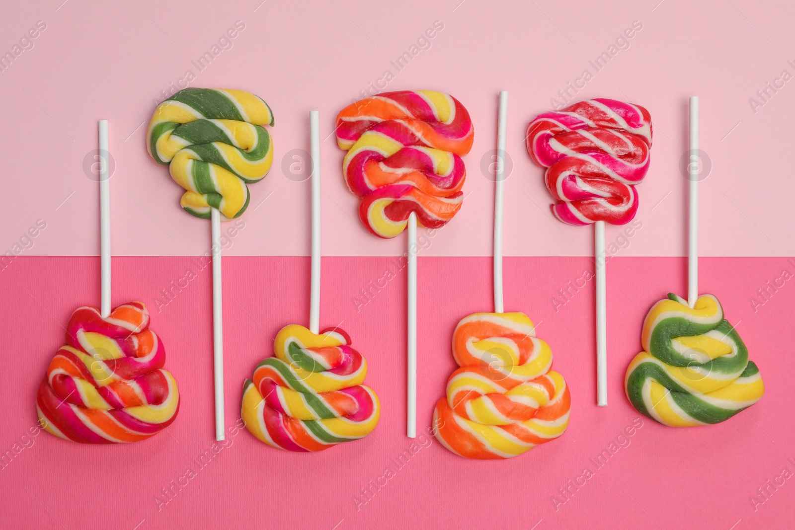 Photo of Sweet lollipops on color background, flat lay