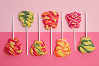 Sweet lollipops on color background, flat lay