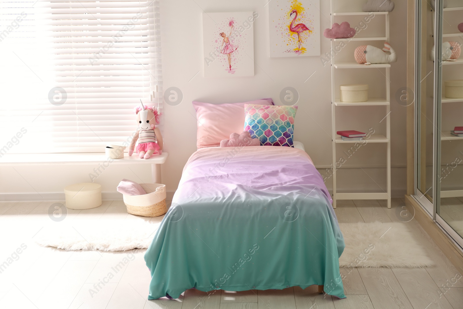 Photo of Bed with beautiful linens in children's room. Modern interior design