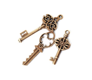 Photo of Bronze vintage ornate keys on white background, top view