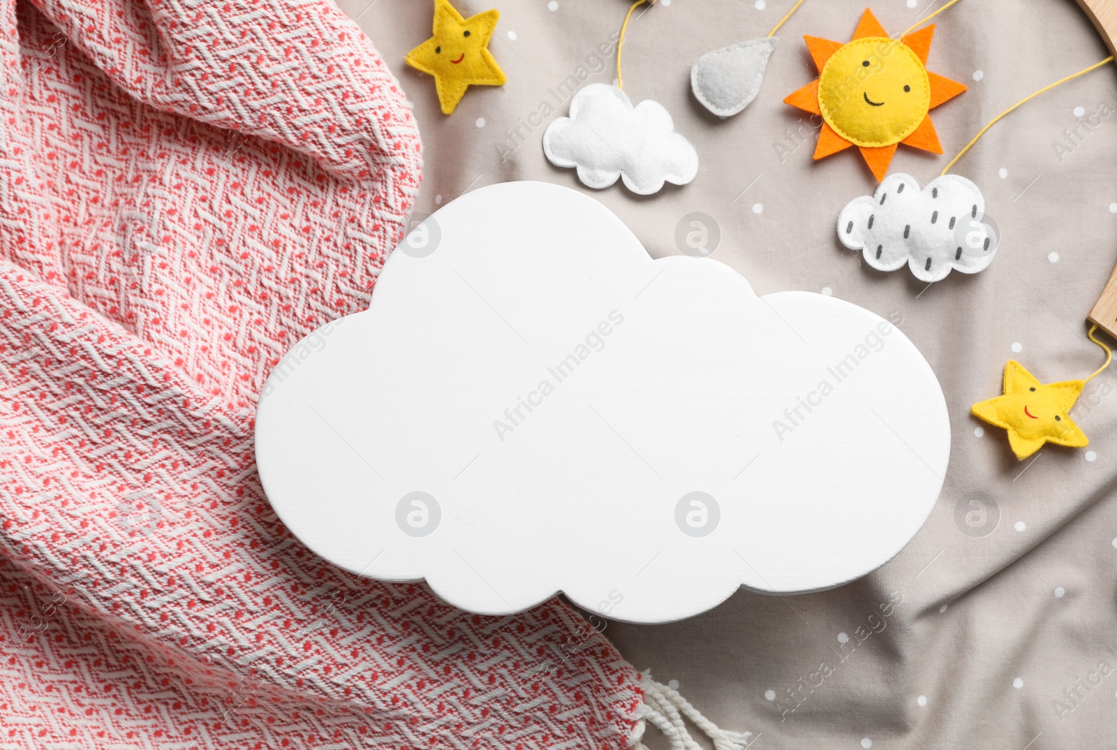 Photo of Flat lay composition with cloud shaped child's night lamp on color fabrics