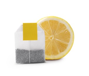 Photo of New tea bag with label and half of lemon on white background