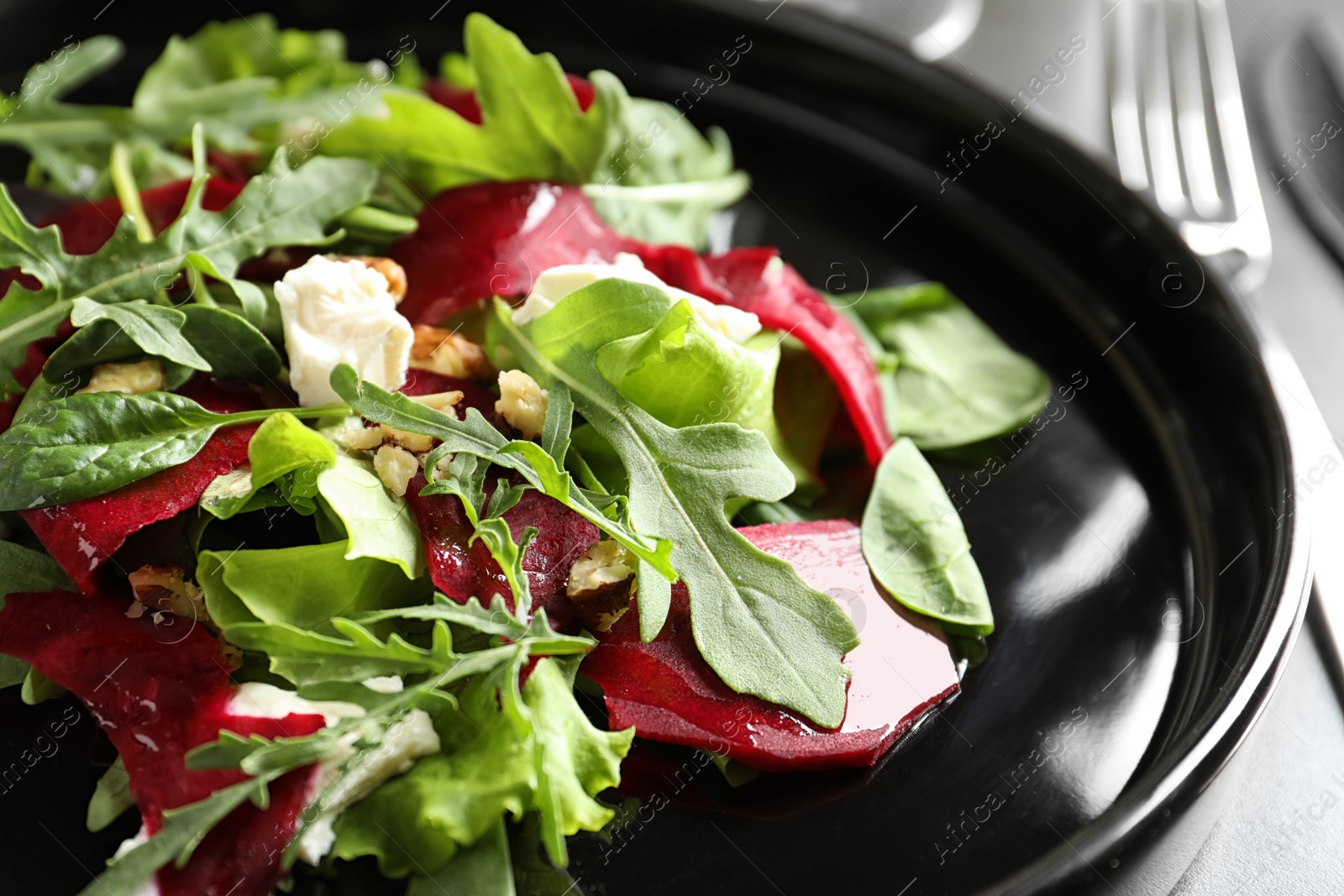 Photo of Delicious salad with beet on plate, closeup
