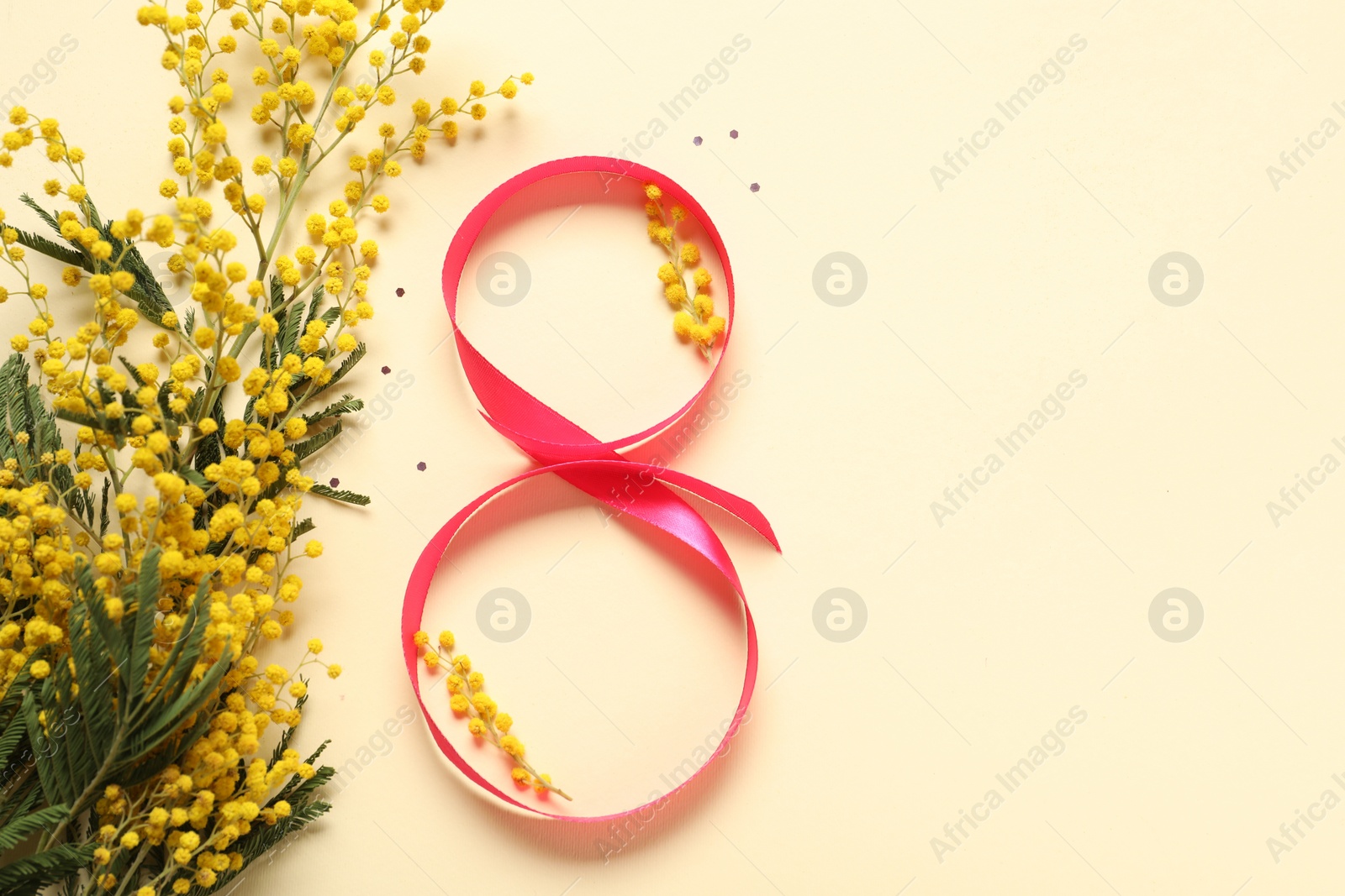 Photo of 8th of March greeting card design with red ribbon, beautiful flowers and space for text on beige background, flat lay. International Women's day