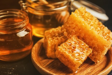 Image of Composition with fresh honey on black table, closeup