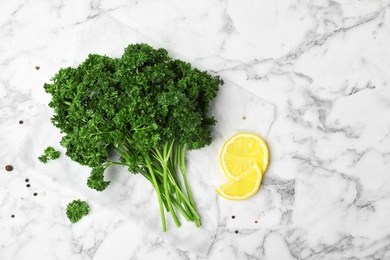 Photo of Flat lay composition with fresh green parsley on marble background