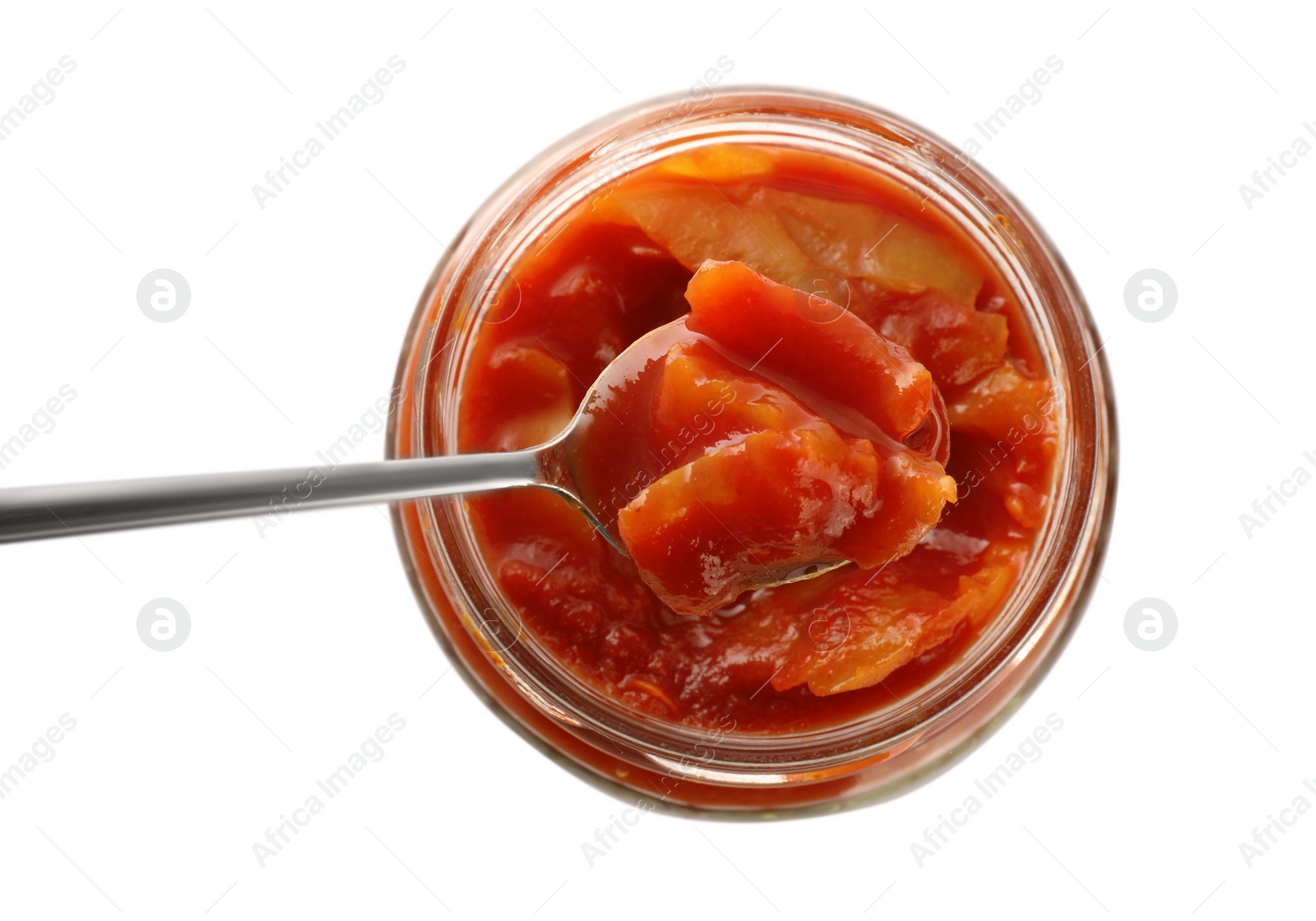 Photo of Glass jar of delicious canned lecho with spoon isolated on white, top view