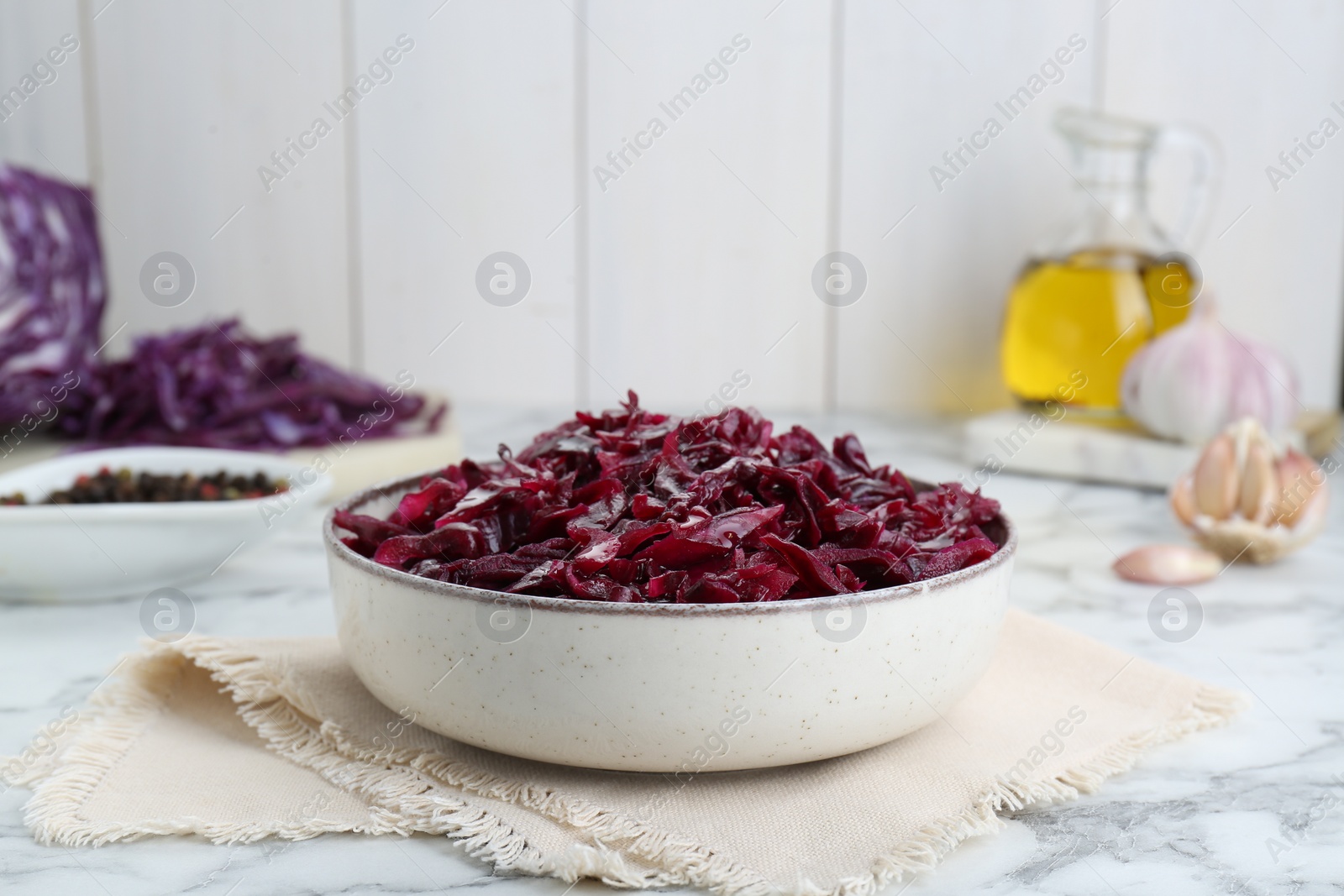 Photo of Tasty red cabbage sauerkraut on white marble table