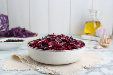 Tasty red cabbage sauerkraut on white marble table