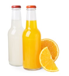 Photo of Delicious kombucha in glass bottles and orange isolated on white