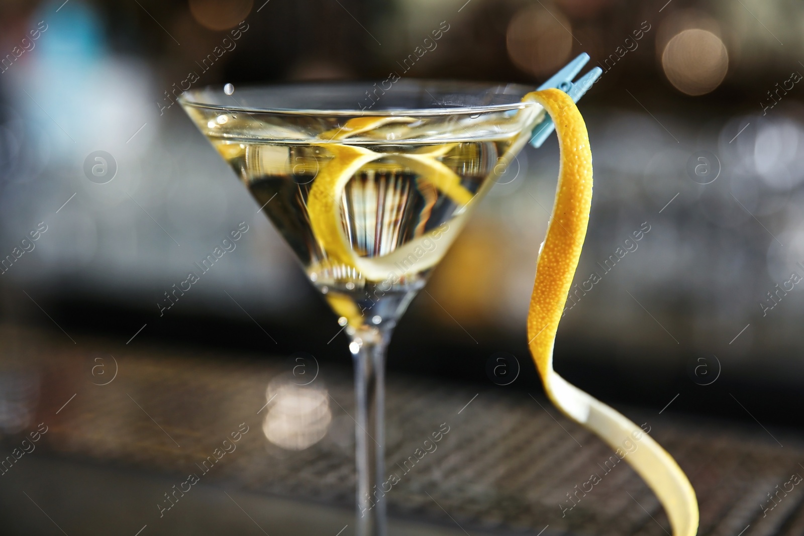 Photo of Glass of lemon drop martini cocktail in bar, closeup