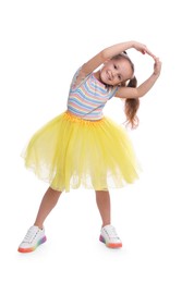 Cute little girl in tutu skirt dancing on white background