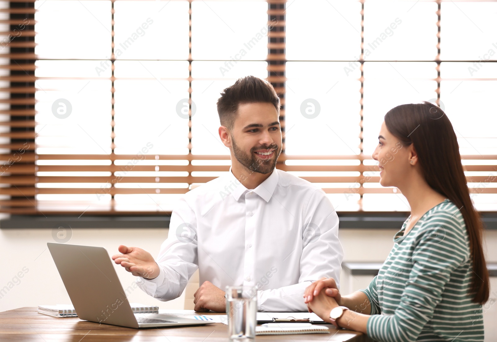 Photo of Insurance agent consulting young woman in office