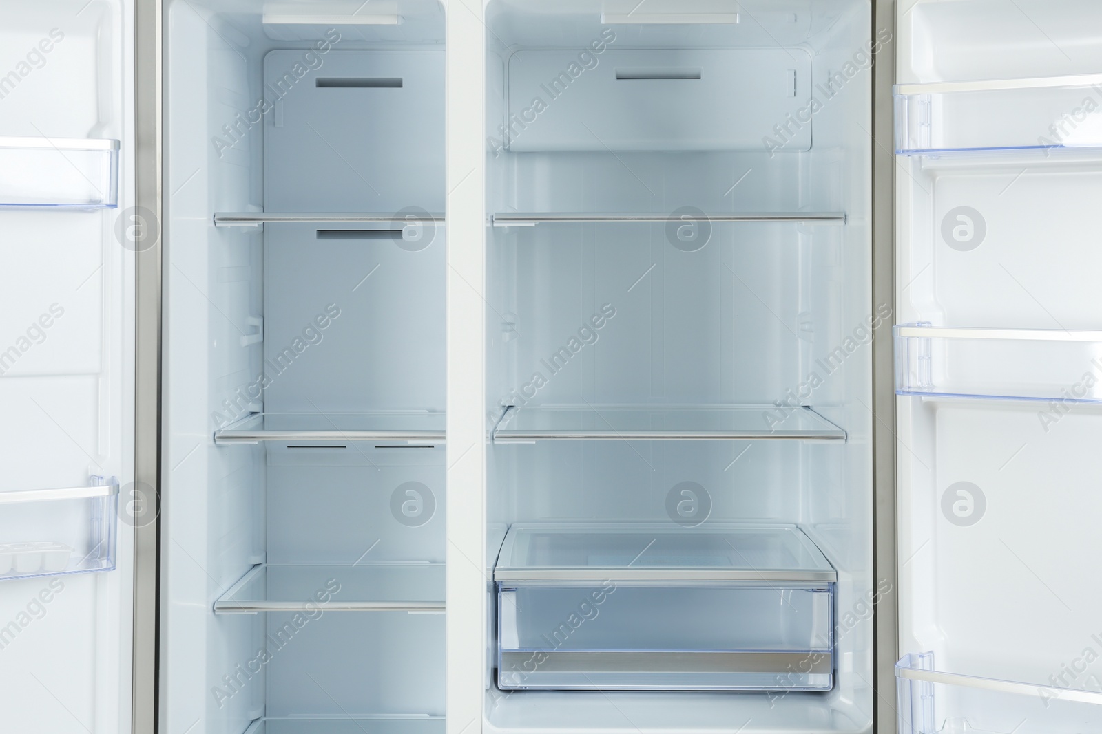 Photo of Shelves of empty modern refrigerator, closeup view