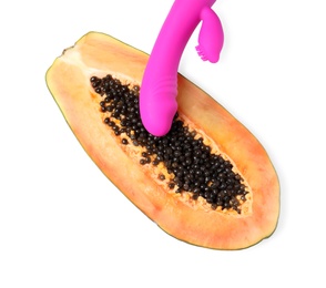 Half of papaya and purple vibrator on white background, top view. Sex concept