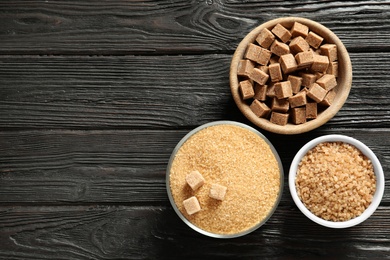 Photo of Bowls with brown sugar on wooden table