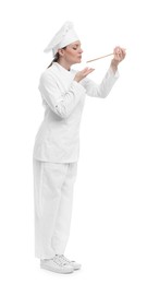 Photo of Happy chef in uniform tasting something on white background