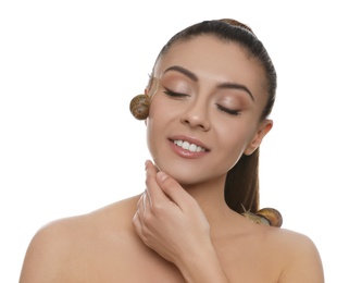 Beautiful young woman with snails on her body against white background