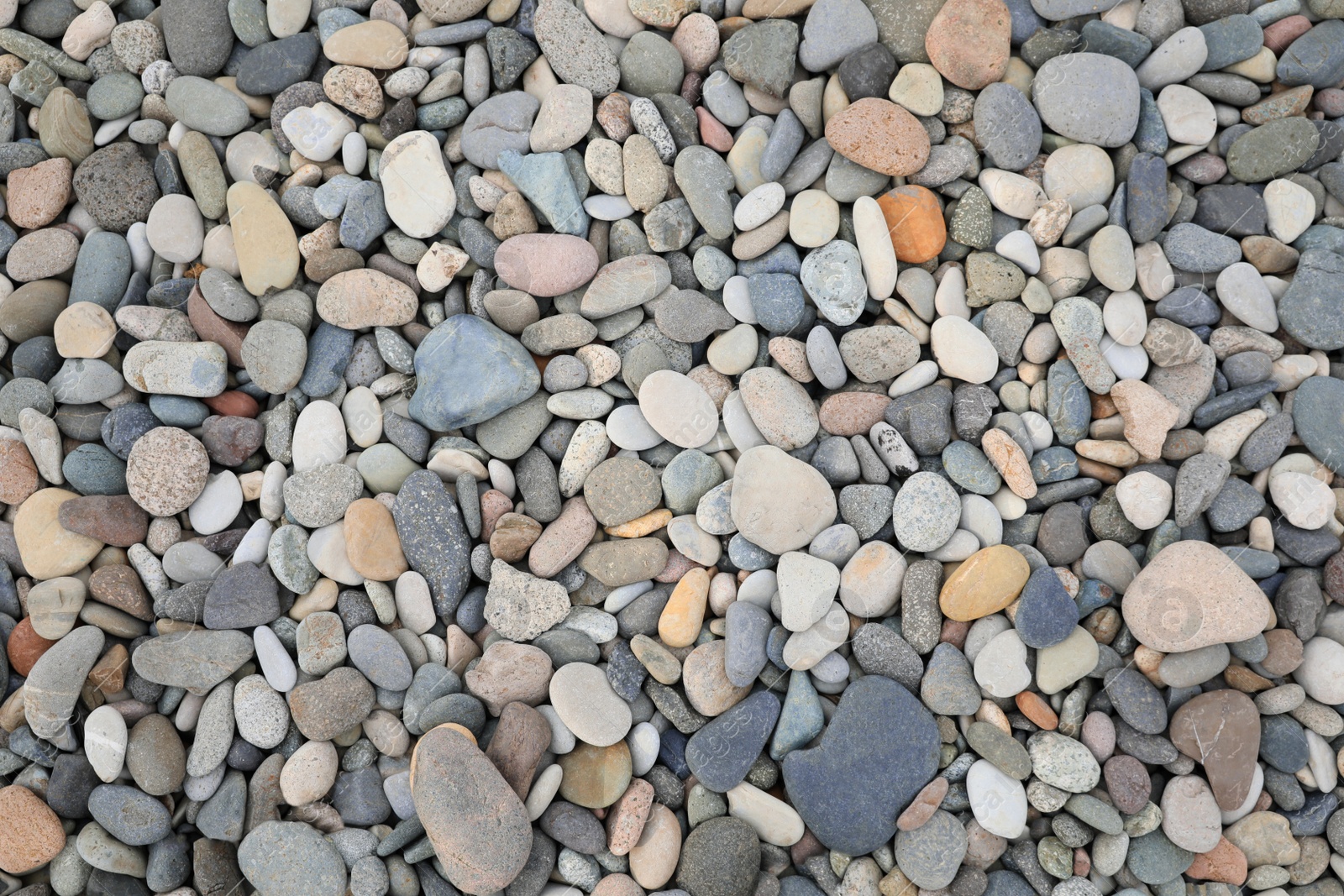 Photo of Pile of pebbles as background, top view