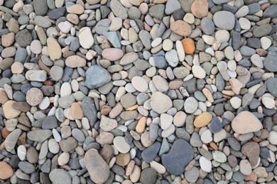 Pile of pebbles as background, top view