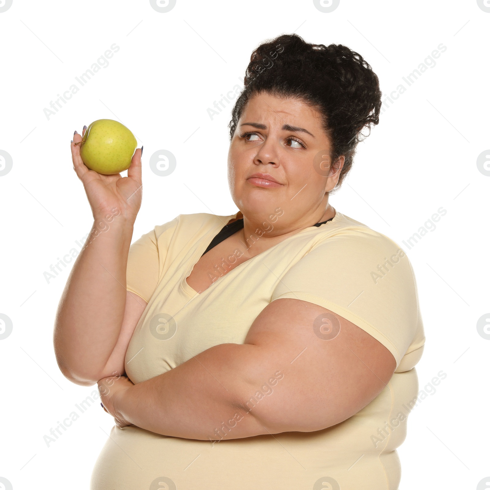 Photo of Emotional overweight woman with apple on white background