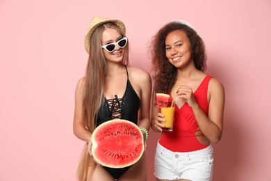 Photo of Beautiful young women in beachwear with watermelon on color background
