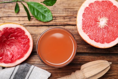 Tasty freshly made grapefruit juice and fruit on wooden table., flat lay