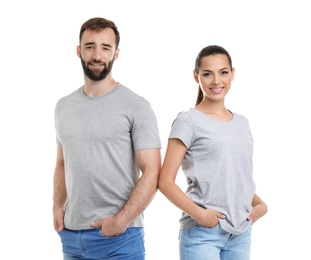 Photo of Young couple in t-shirts on white background. Mockup for design