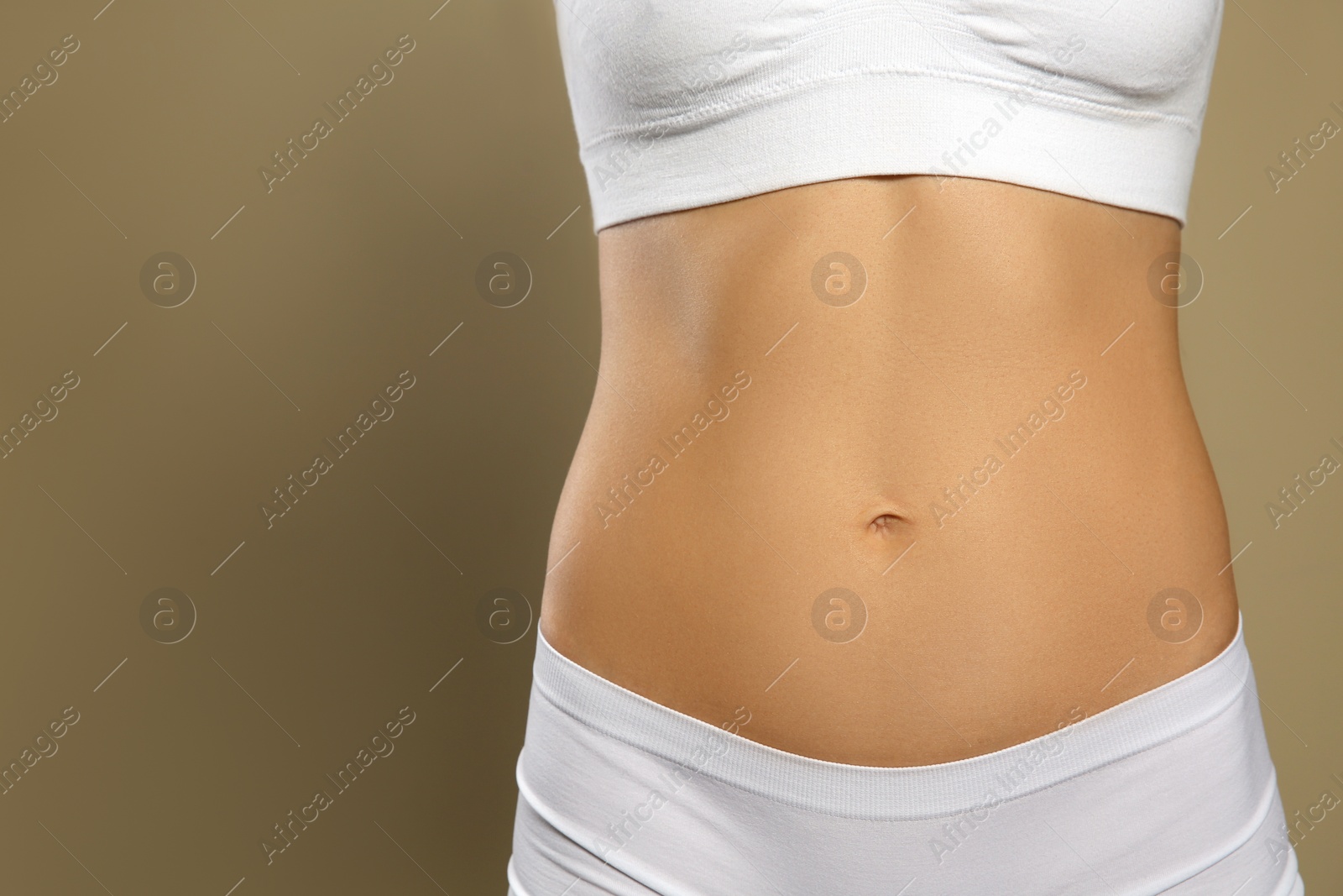 Photo of Woman in underwear against beige background, closeup. Space for text