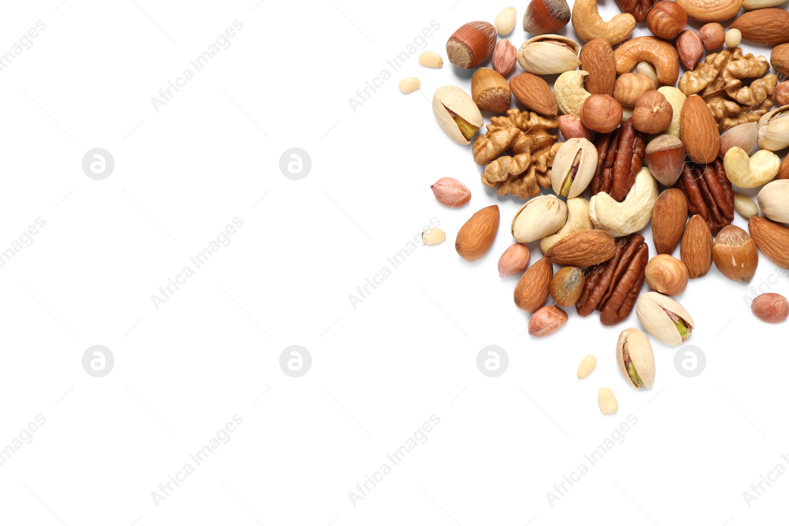 Photo of Different delicious nuts on white background, flat lay. Space for text