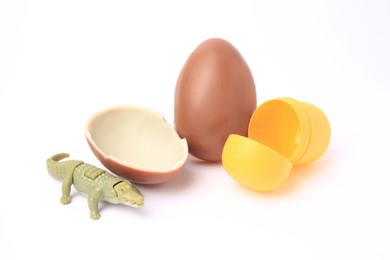 Photo of Slynchev Bryag, Bulgaria - May 24, 2023: Halves of Kinder Surprise Egg, plastic capsule and toy crocodile isolated on white