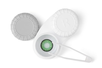 Photo of Case with green contact lenses and tweezers isolated on white, top view