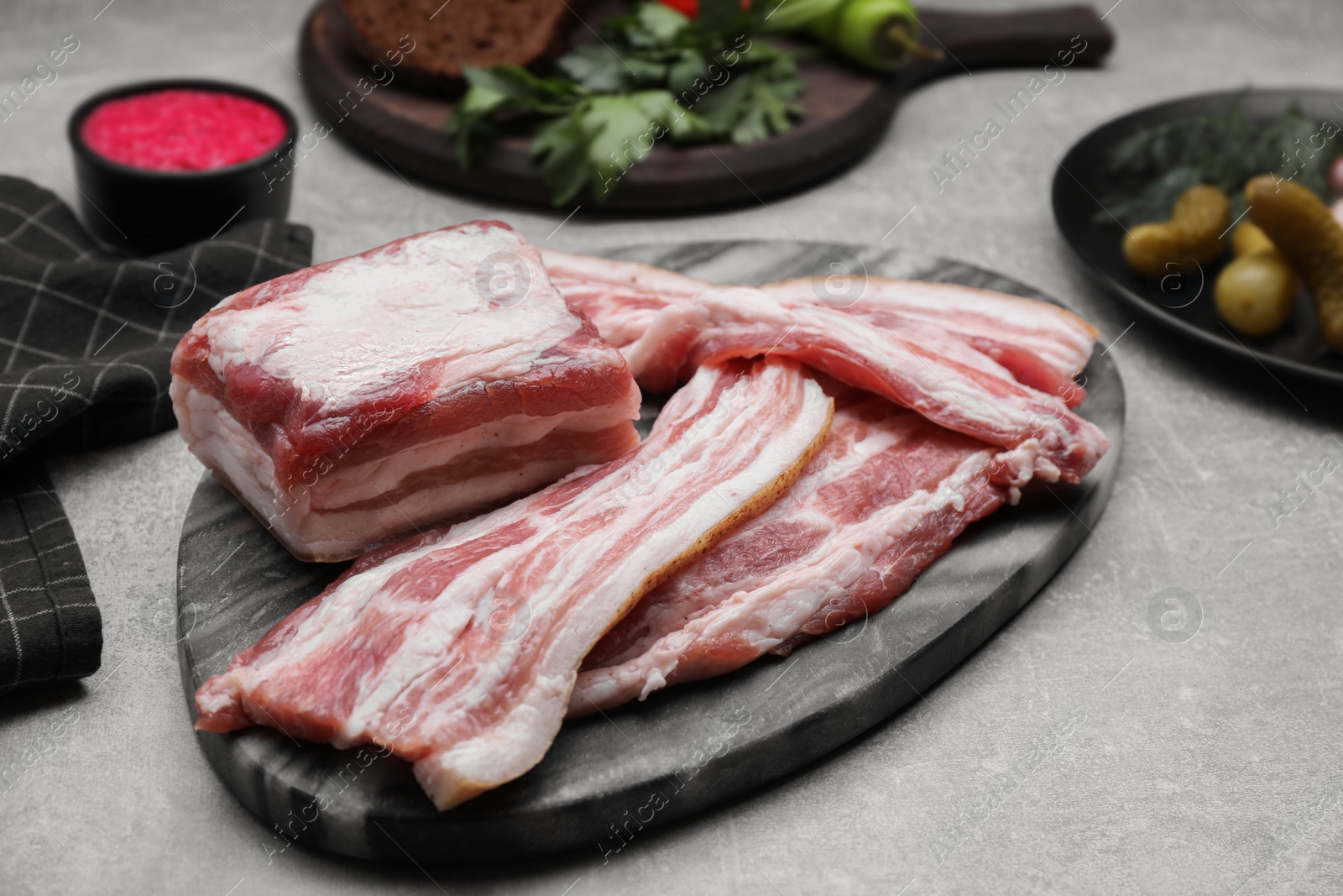 Photo of Tasty pork fatback on grey table, closeup