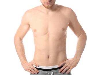 Photo of Young man with slim body on white background, closeup