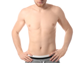 Young man with slim body on white background, closeup