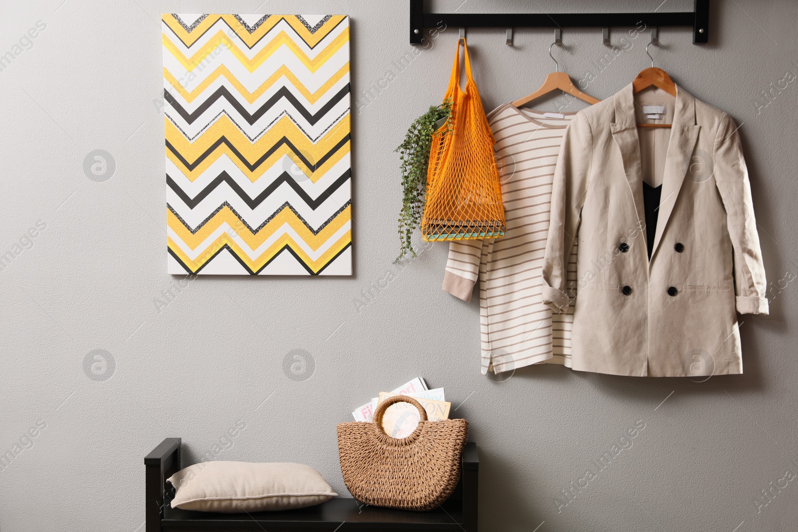 Photo of Hallway interior with stylish furniture, clothes and accessories