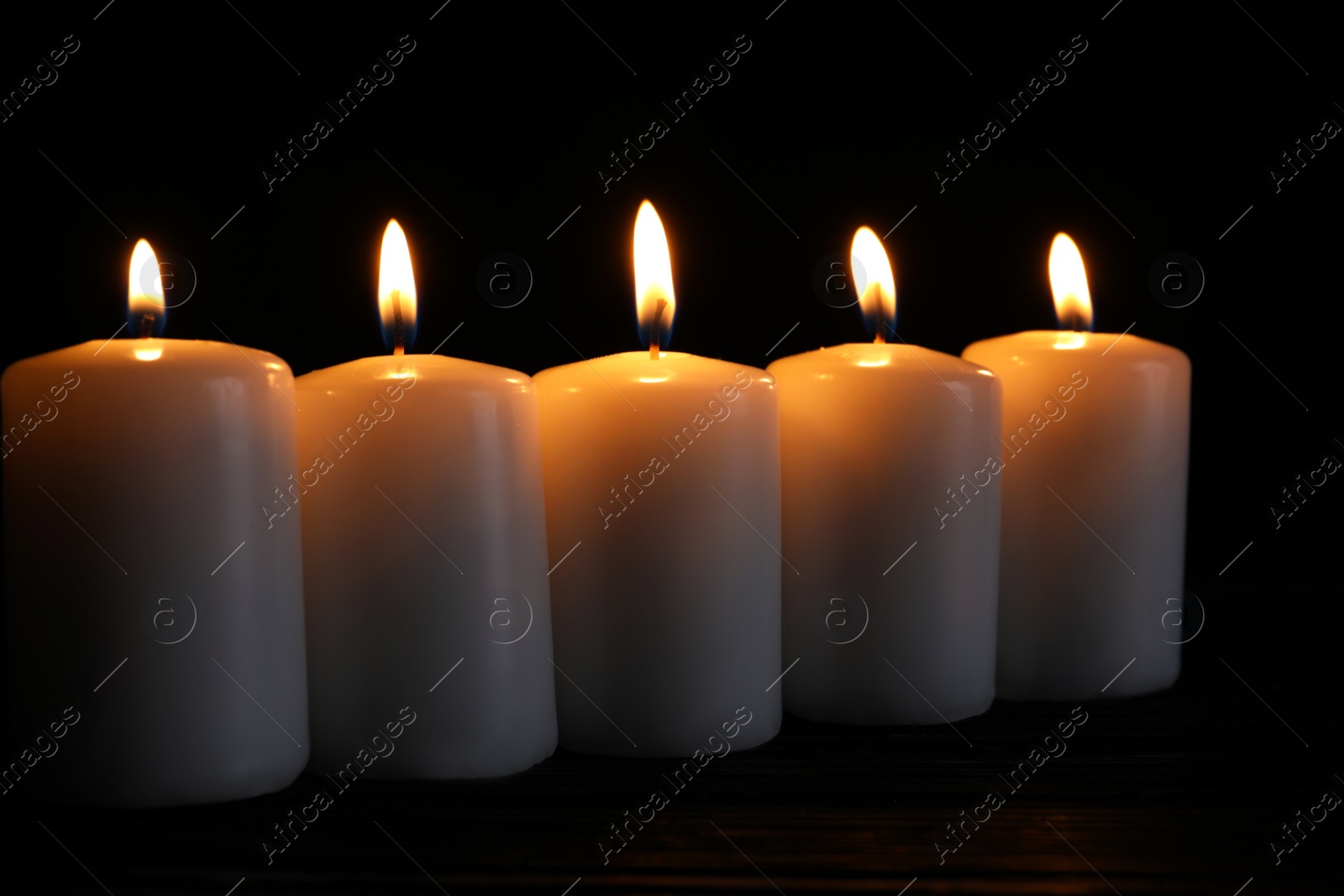 Photo of Many burning candles on table. Memory day