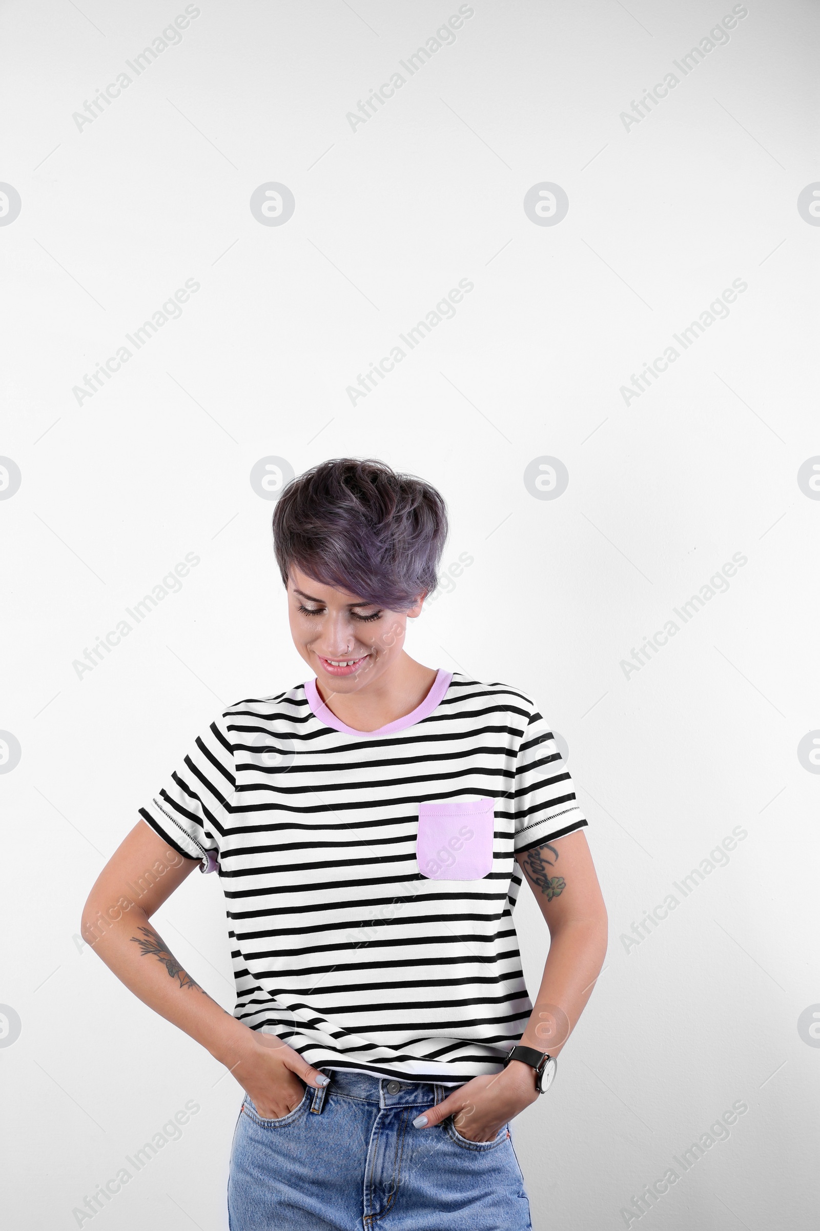 Photo of Trendy young woman with tattoos on white background